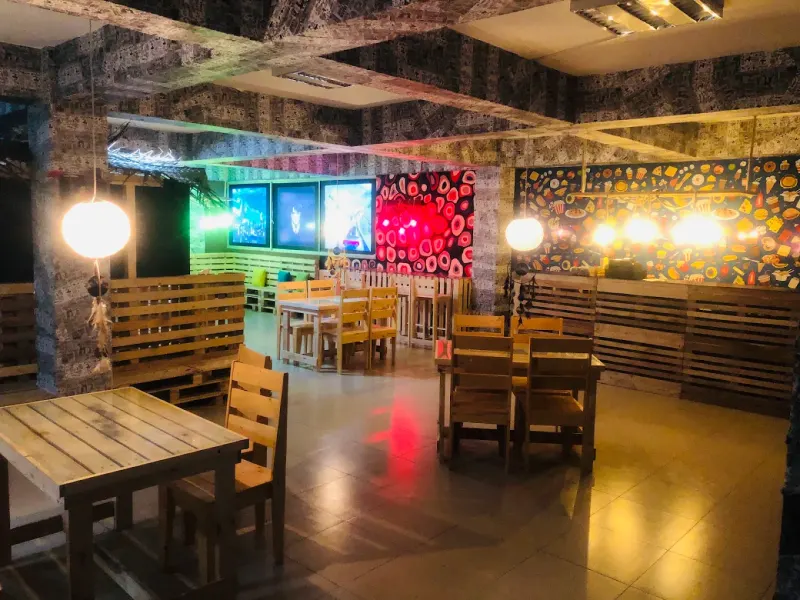 Inside Hogwarts Cafe: wooden tables under glowing lanterns