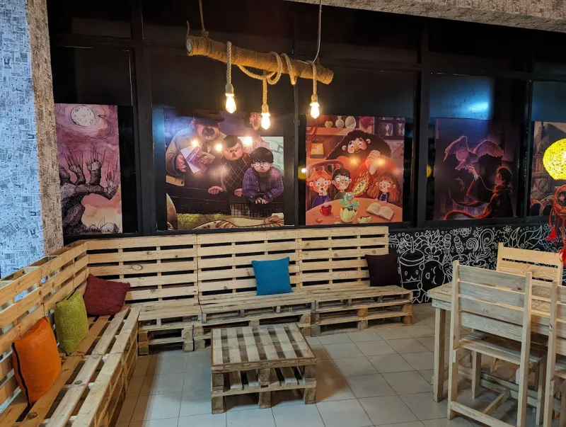 Pallet-wood lounge seating in front of painted murals