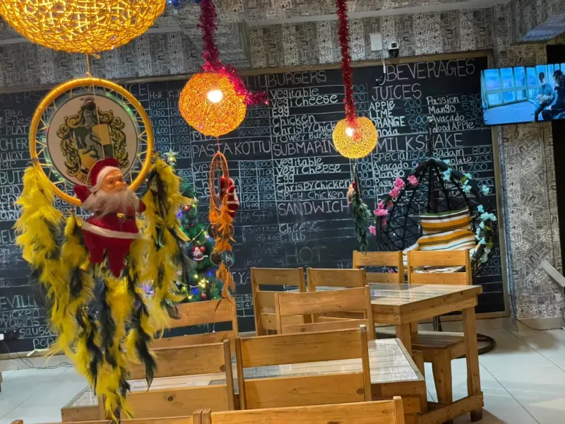 A Hufflepuff dreamcatcher hanging in front of the café chalkboard menu